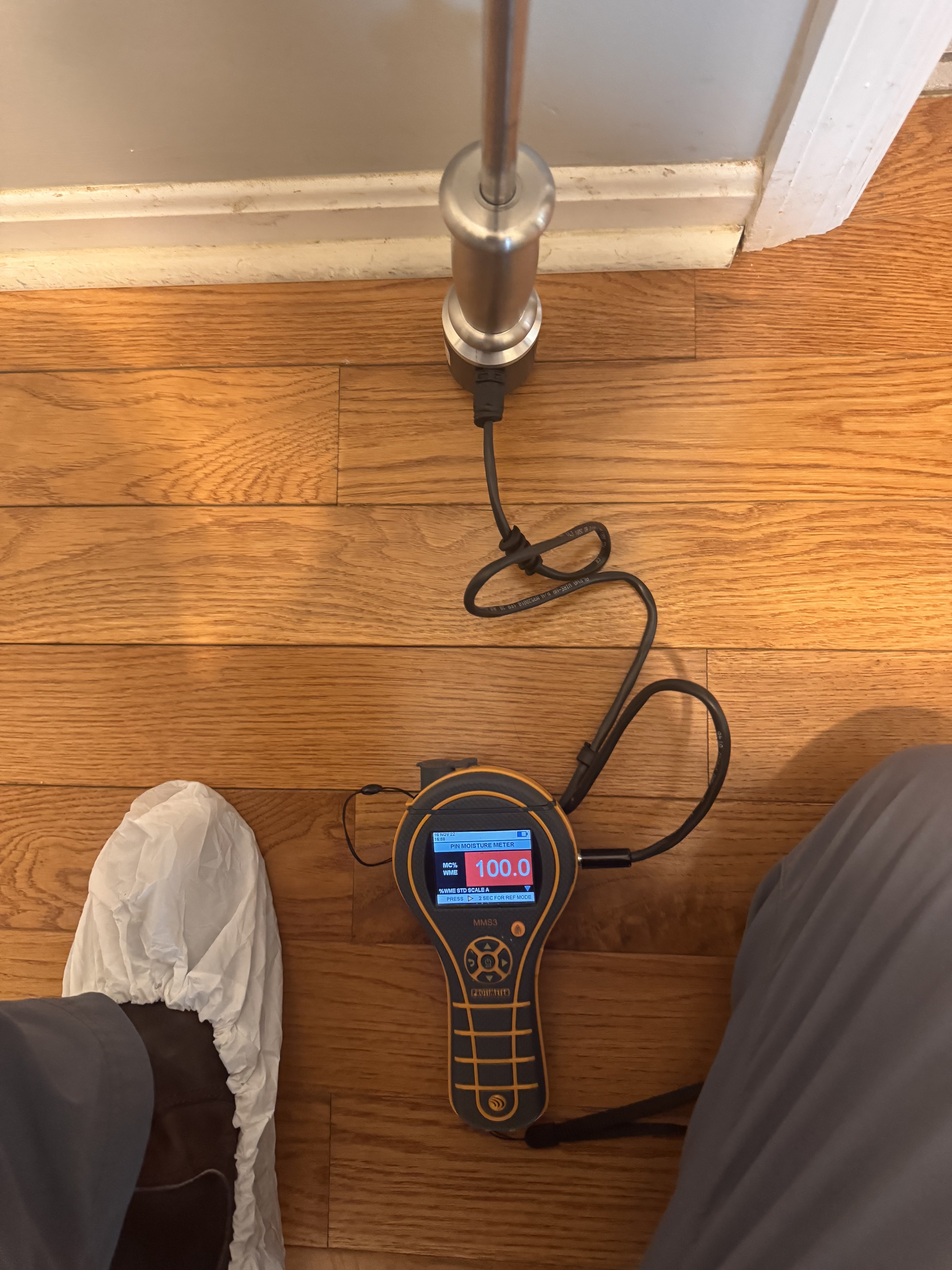 IRS technician using moisture meter to map water damage in a Salt Lake City home
