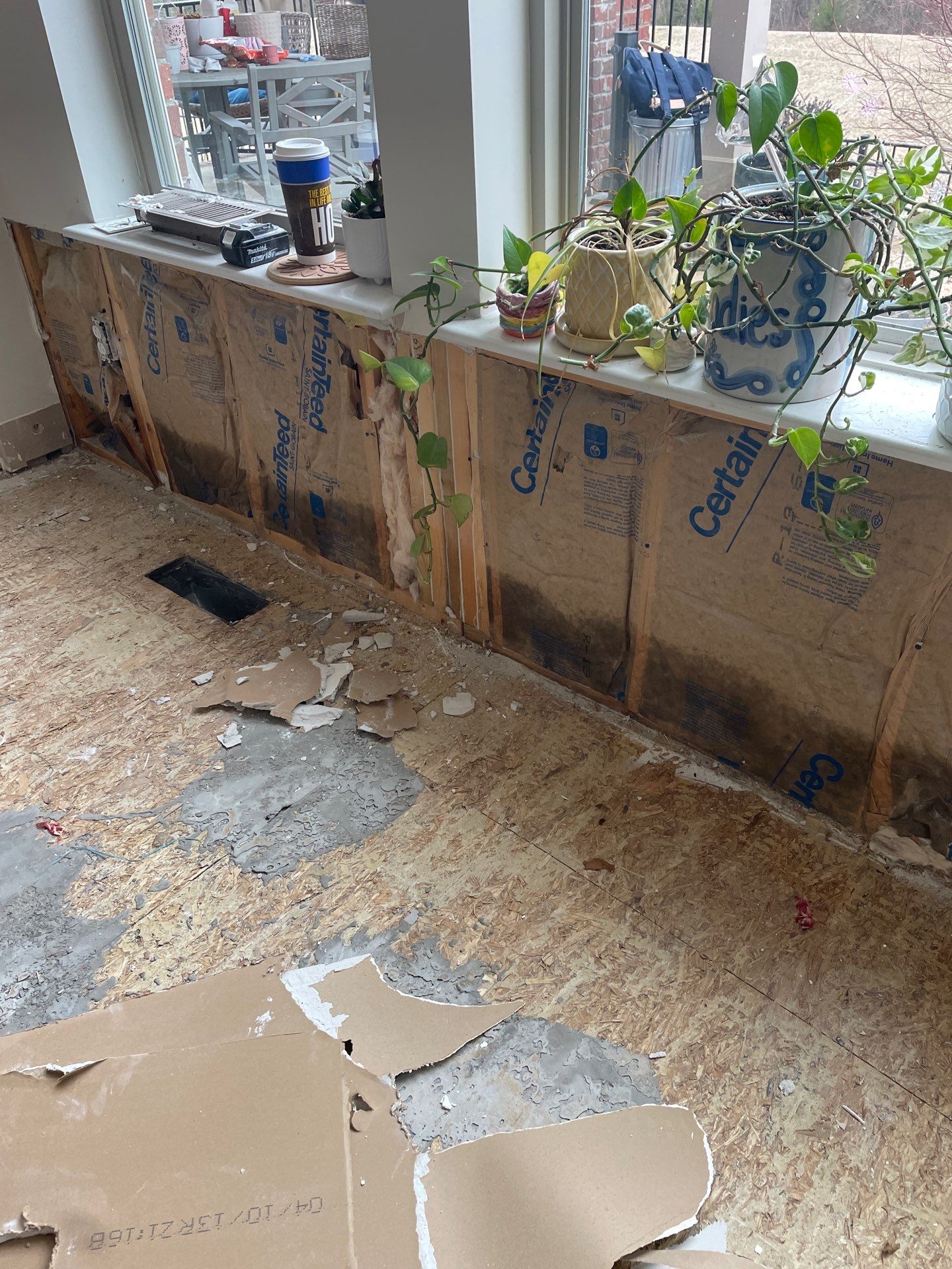 Damaged wall insulation and subfloor after storm damage in Salt Lake City