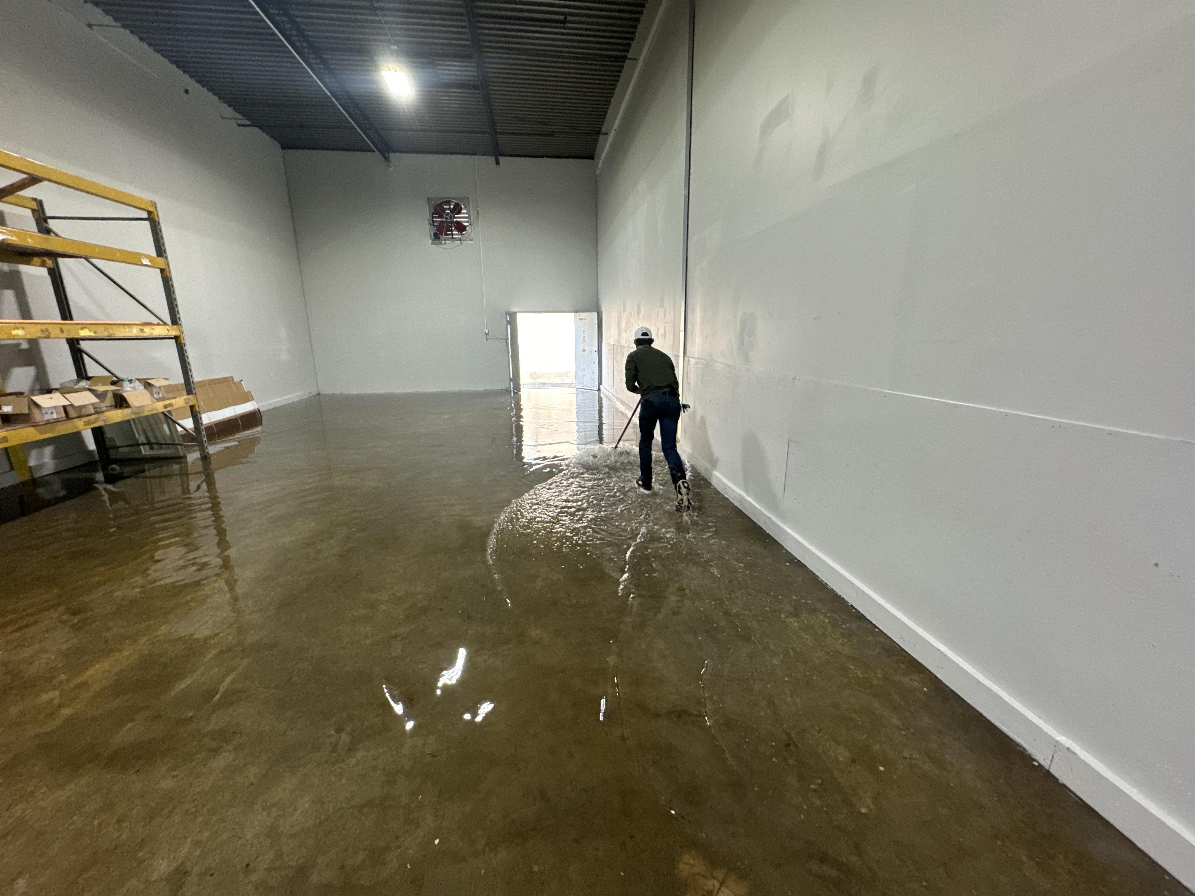 IRS crew member extracting standing water from a Salt Lake City commercial building
