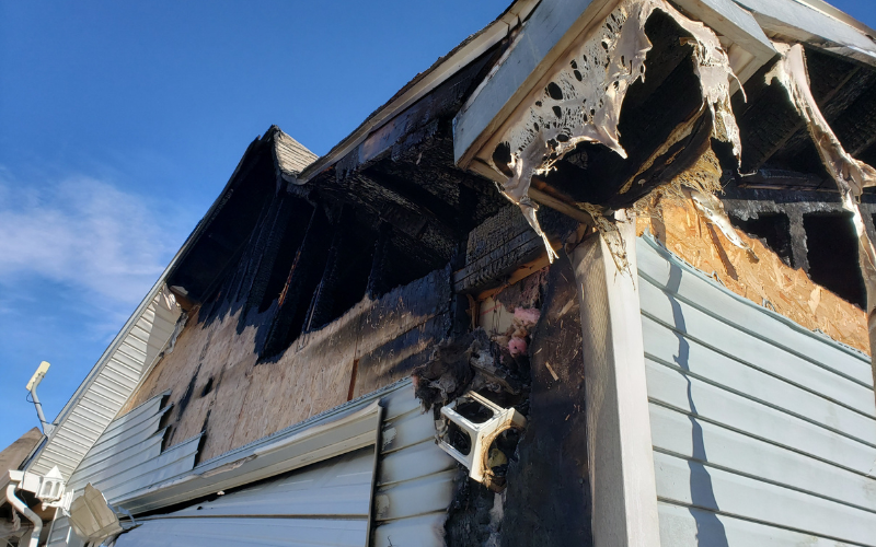 Exterior of a Salt Lake City house with fire damage to roof and siding